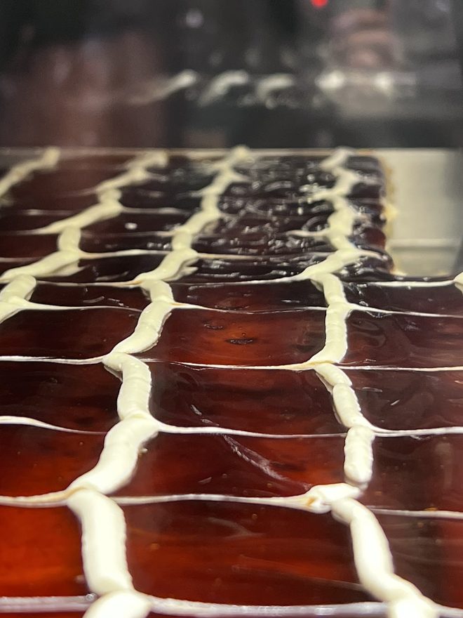 A tray of cream-piped baklava pastries.
