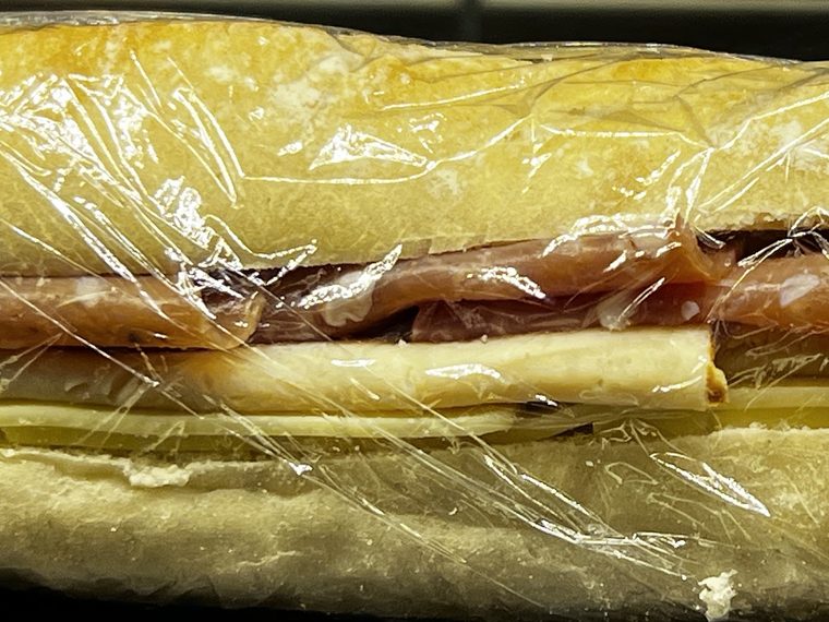 A cheese and cured meat baguette.